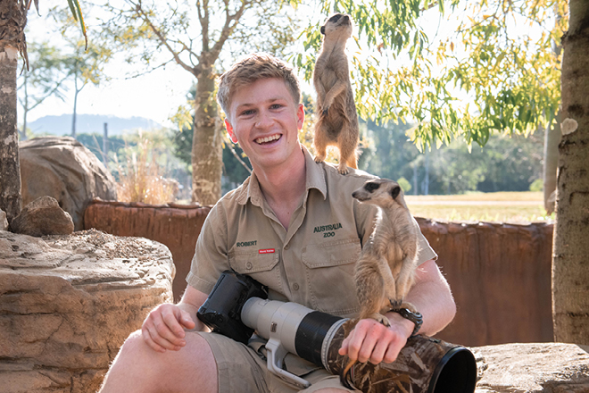 Robert Irwin and two guests with Meerkats perched on his shoulders.